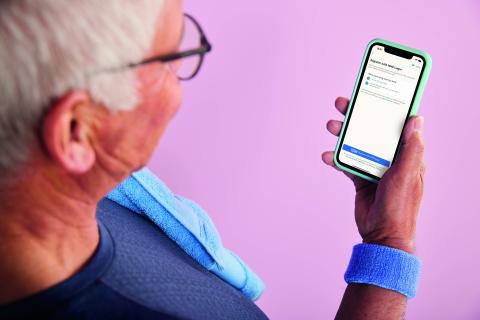 Man holding phone NHS Login 